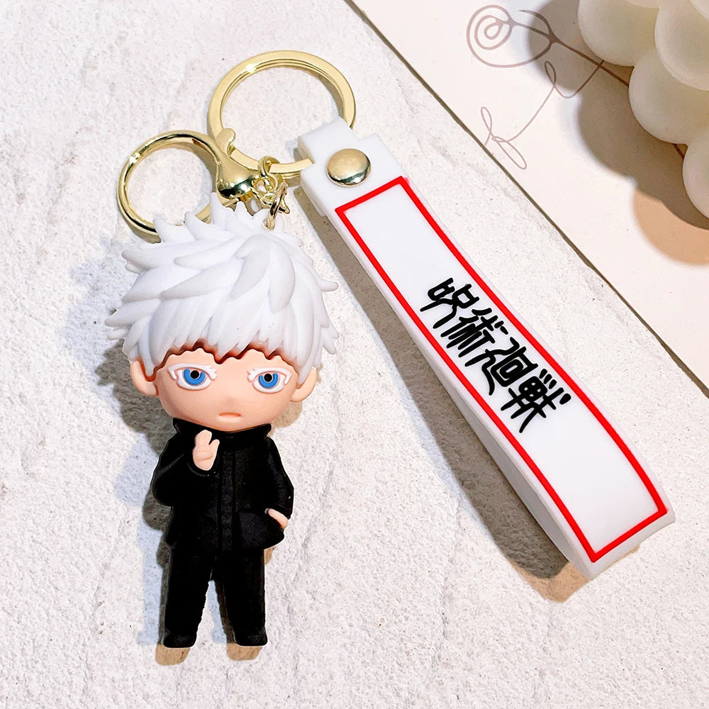 Porte-clé figurine cheveux blancs, tenue noire, lanière blanche bordée rouge