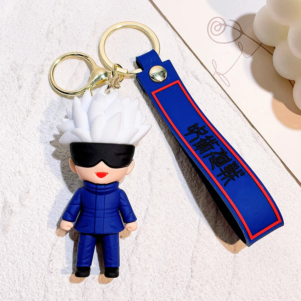 Porte-clé figurine Gojo Satoru à lanière bleue, anneau doré et costume bleu.