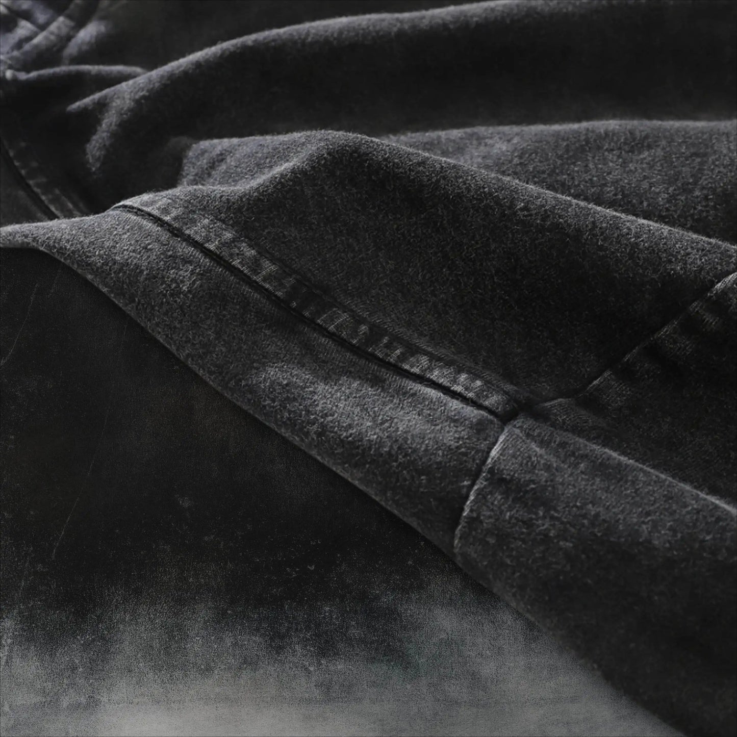 Dark charcoal T-shirt close-up of crew neck seam and stitched edge