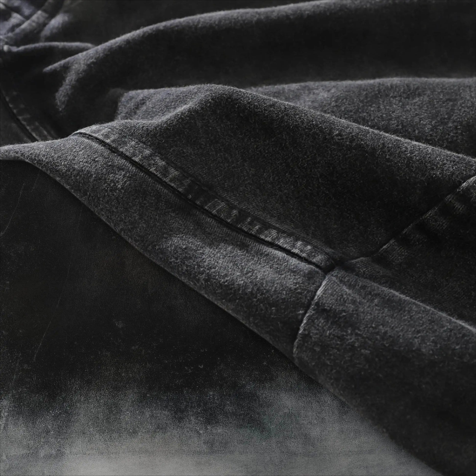 Dark charcoal T-shirt close-up of crew neck seam and stitched edge