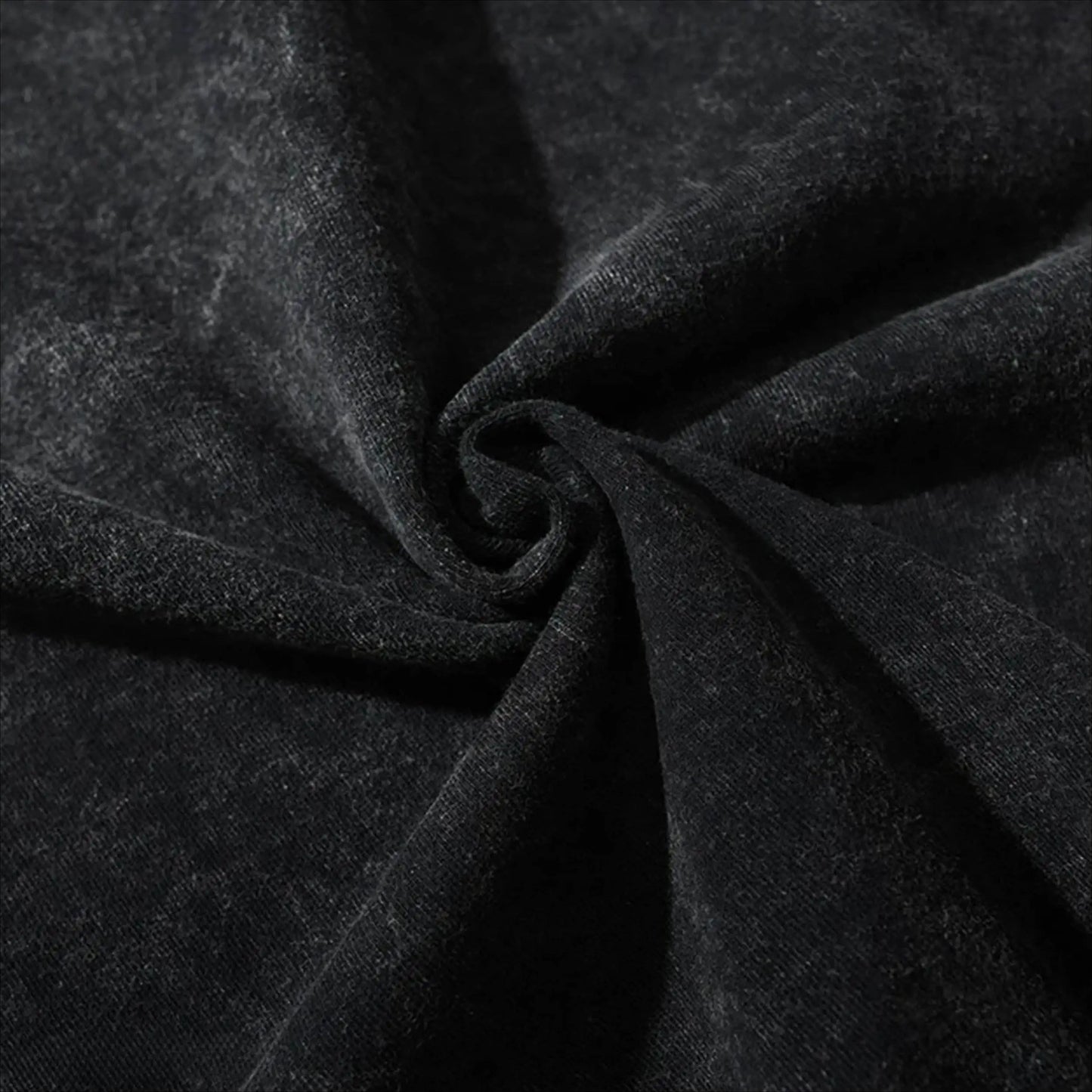 Close-up of dark charcoal cotton T-shirt fabric with visible weave and folds