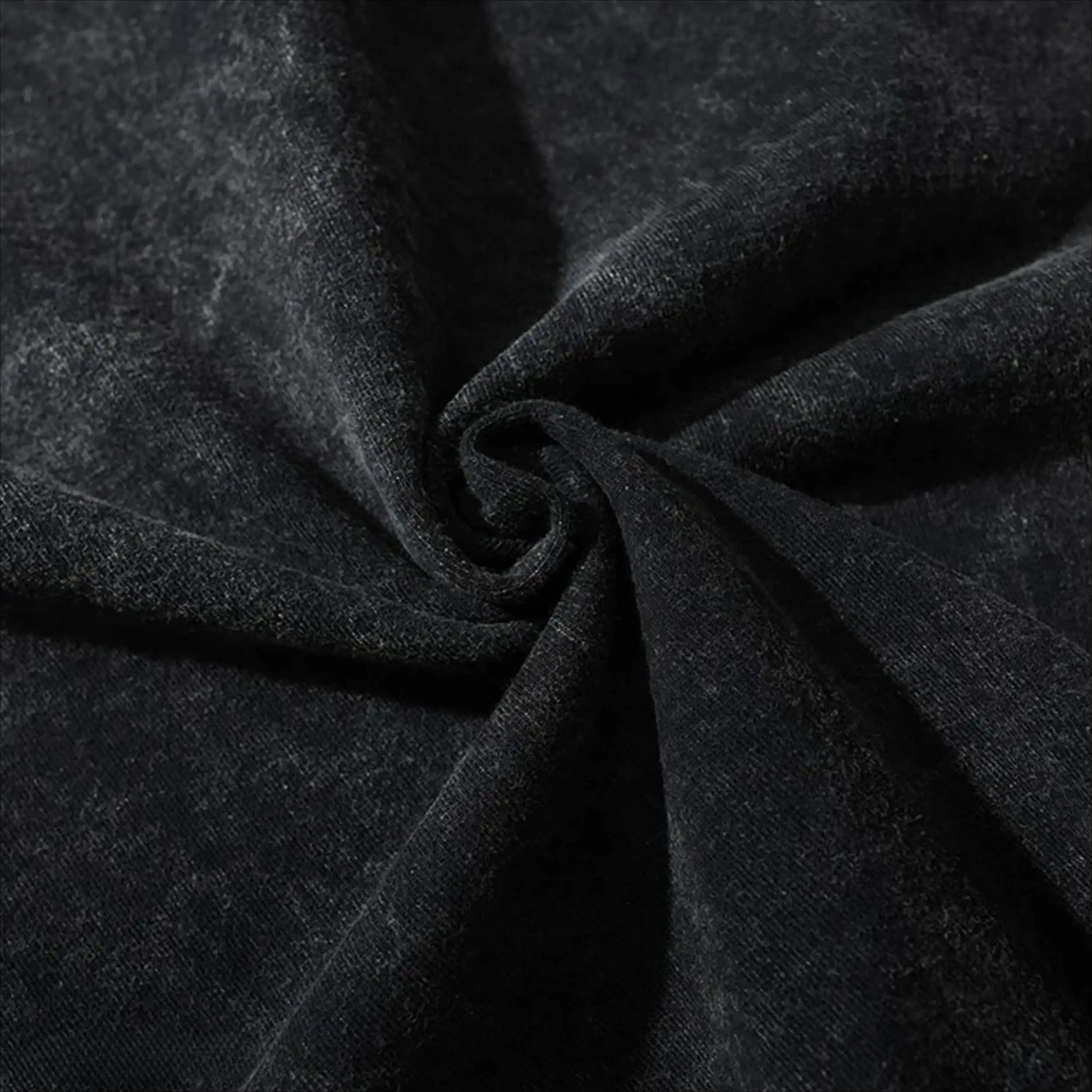 Close-up of dark charcoal cotton T-shirt fabric with visible weave and folds