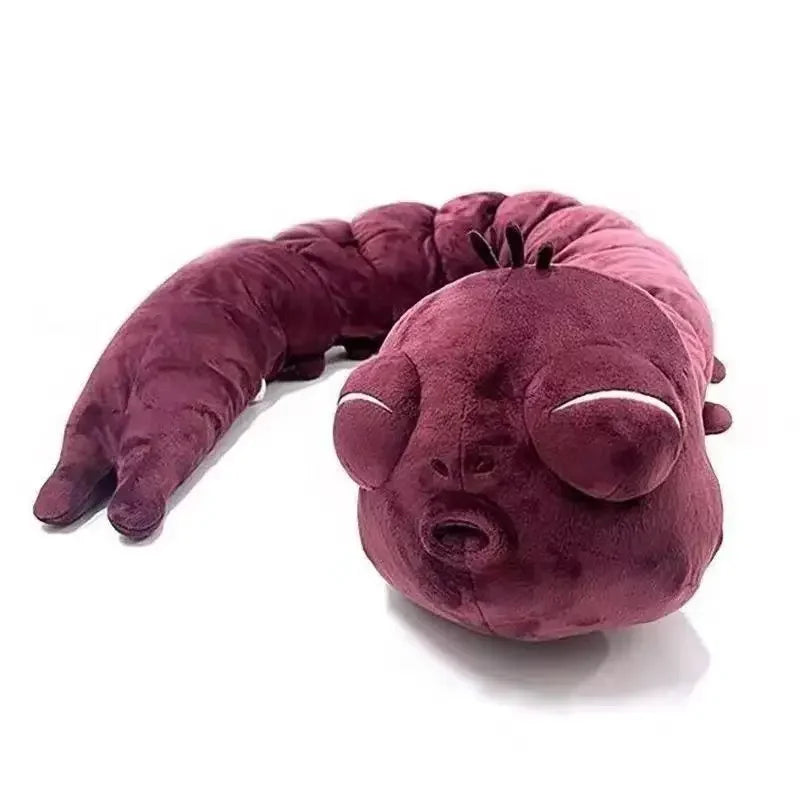 Accessoire plush violet en forme de tête/mascotte rembourrée, bouche et yeux brodés.